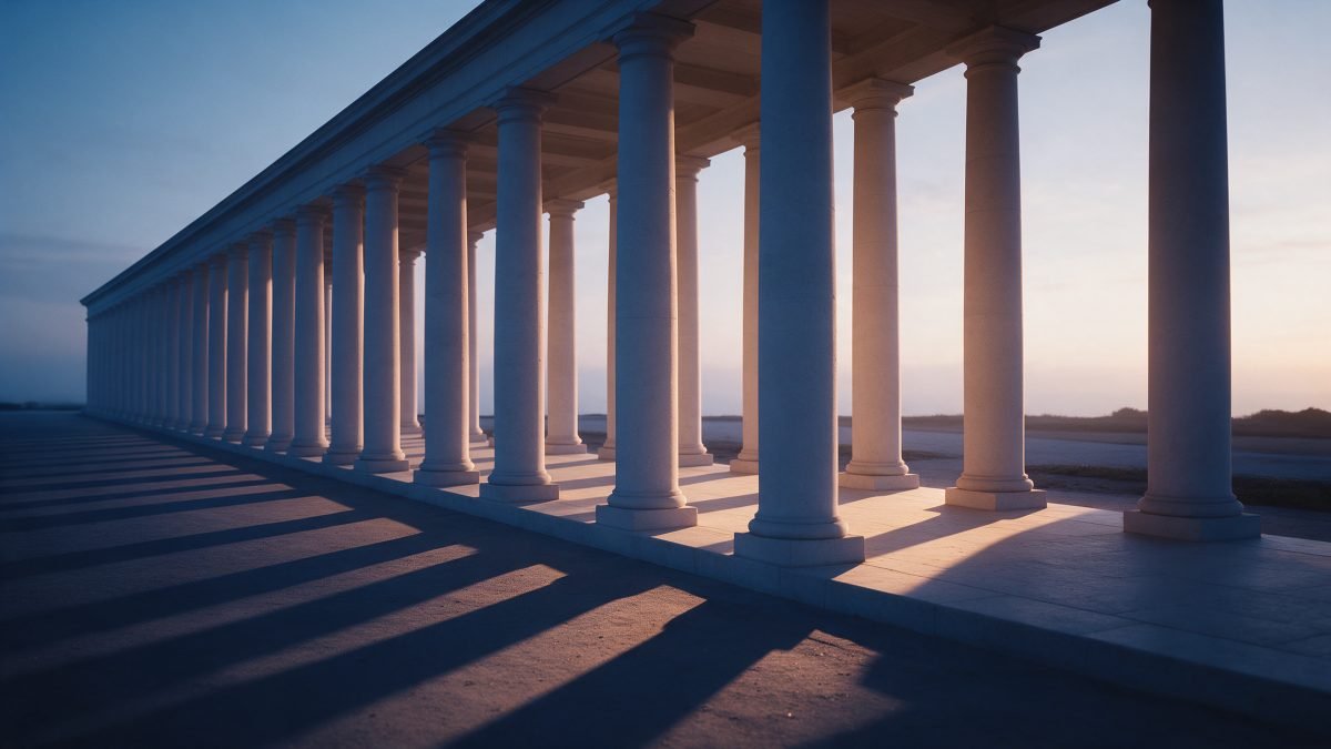 A pale stone colonnade at early dawn with soft cool light turning warm